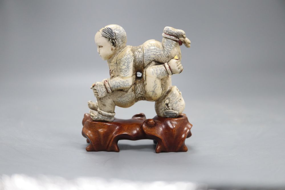 Two Chinese wooden stands (boys), height 9cm